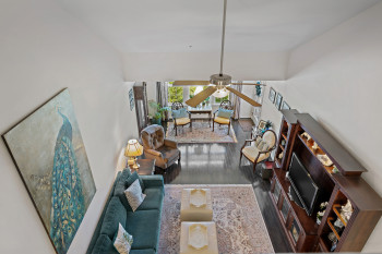 View into living room, sitting area from open loft area above.