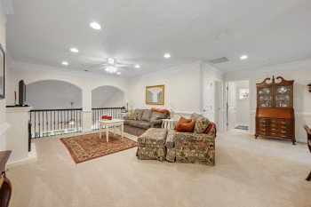 2nd Floor Loft Living area with crown molding, light carpet, recessed lighting, and ceiling fan. Beautiful arched open area with railing looks down into living room below.
