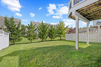 View of yard with a residential view and a balcony