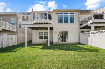 Rear view of property featuring fences on two sides, upper deck and not shown in this shot but evergreen tree lined for privacy!