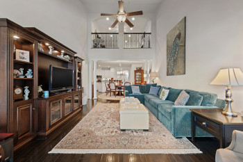 Living room with a towering ceiling, abundant wall space and recessed lighting