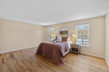 Primary bedroom with elegant hardwood floors