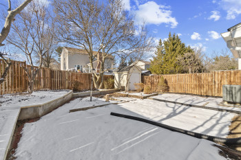 Large fenced backyard with storage shed