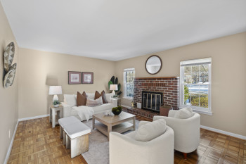 Bright living room with brick fireplace