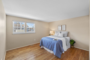 Bright 2nd bedroom with large window & wood floors