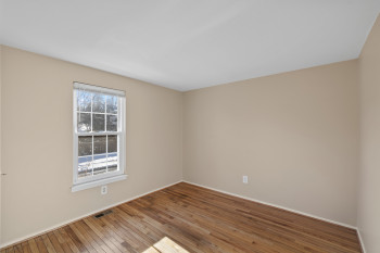 Upper level bedroom 1 with hardwood floors