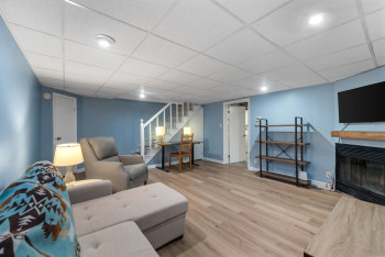 Large lower level Recreation Room with wood-burning fireplace