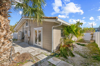 Back of house featuring a fenced backyard and french doors