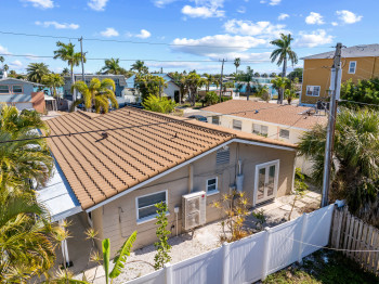 Rear view of house with a residential view, a tile roof, a fenced backyard, and a patio/porch.