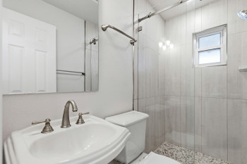 Bathroom #2 with toilet , vanity and a shower stall
