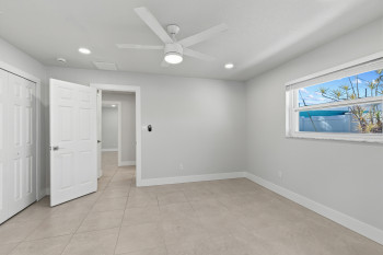 Bedroom #2 featuring ceiling fan, access to exterior covered porch, recessed lighting, a closet, and light tile patterned flooring