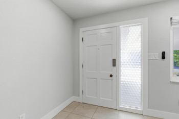 Foyer entrance featuring baseboards and light tile patterned floors