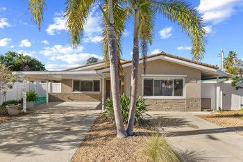 View of front of home with a carport, concrete driveway