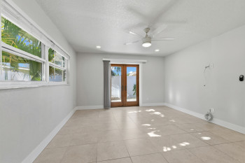 Primary Bedroom with French Doors, ceiling fan, a textured ceiling, light tile patterned floors, and recessed lighting