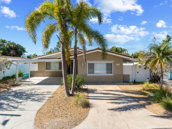 Single story home featuring driveway, and covered carport.