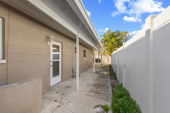 Fenced backyard featuring a patio/porch area.