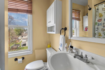 Full bath featuring toilet and a shower with curtain