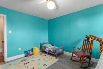 Bedroom featuring wood finished floors and ceiling fan