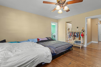 Bedroom featuring dark wood-type flooring and ceiling fan