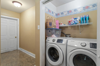 Laundry room featuring baseboards and washing machine and clothes dryer