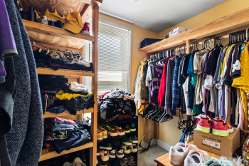 Walk in closet featuring light colored carpet