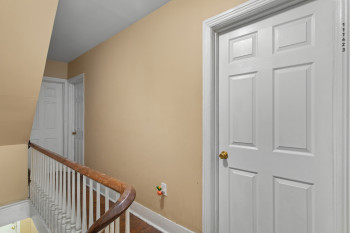 Hall with an upstairs landing and wood finished floors