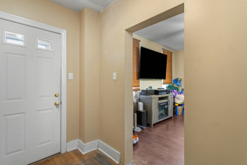 Foyer entrance featuring dark wood-type flooring and baseboards