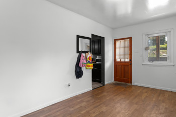 Foyer featuring baseboards and dark wood-style floors