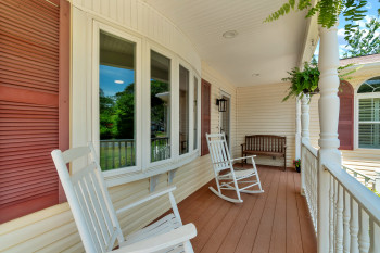 Relax in the shade watching the world go by on your covered front porch featuring a composite deck.
