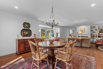 Original random width hardwood floors flows from the Dining area to the Fireplace.