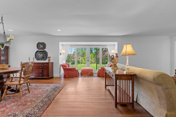 Open concept living space featuring wood-finish flooring, light gray wall tones, and recessed lighting