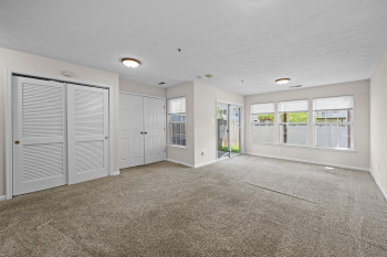 Spacious room featuring neutral carpeting and fresh paint throughout