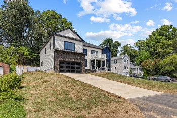 Modern facade with horizontal siding and stone-clad lower level