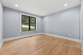 Bright interior with recessed lighting, light-toned wood-finish flooring, and white trim