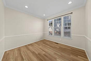 Recessed lighting, wood-finish flooring, crown molding, and wainscoting