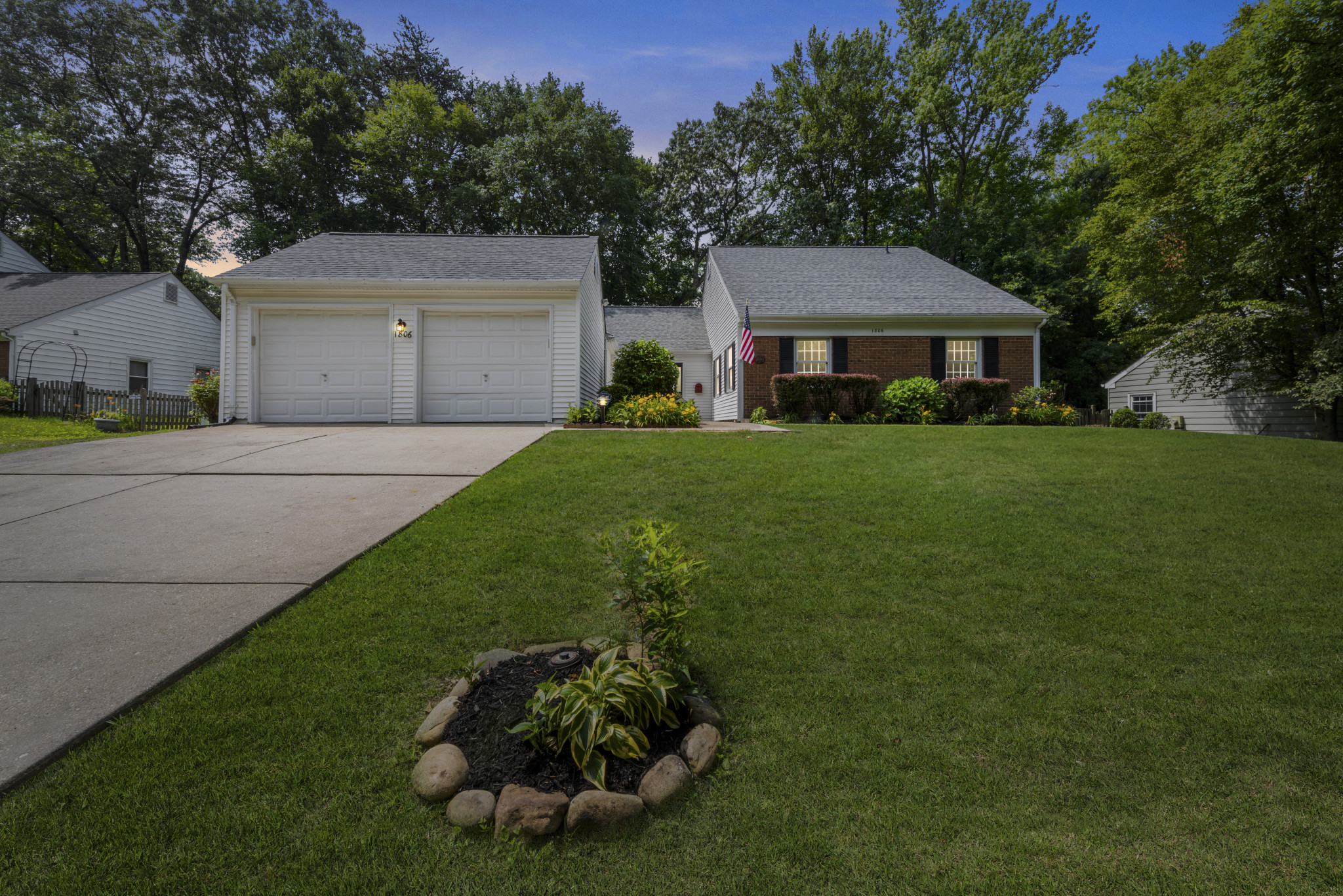 View of front of property with driveway, an attached garage, and new architectural shingles