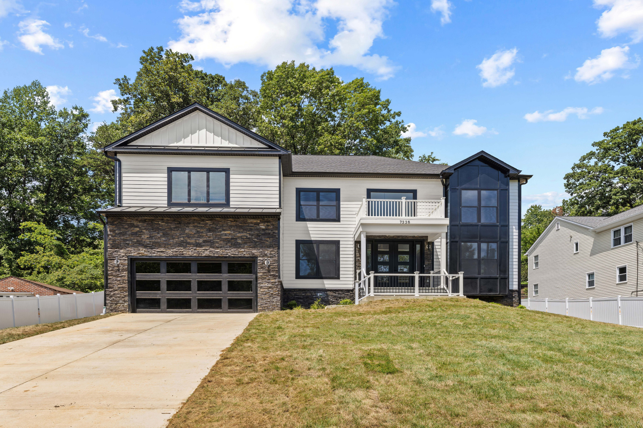 Contemporary-style exterior with stone veneer accents