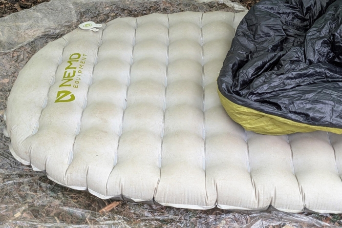 Top view of the NEMO Tensor Elite Sleeping Pad with a sleeping bag folded over it