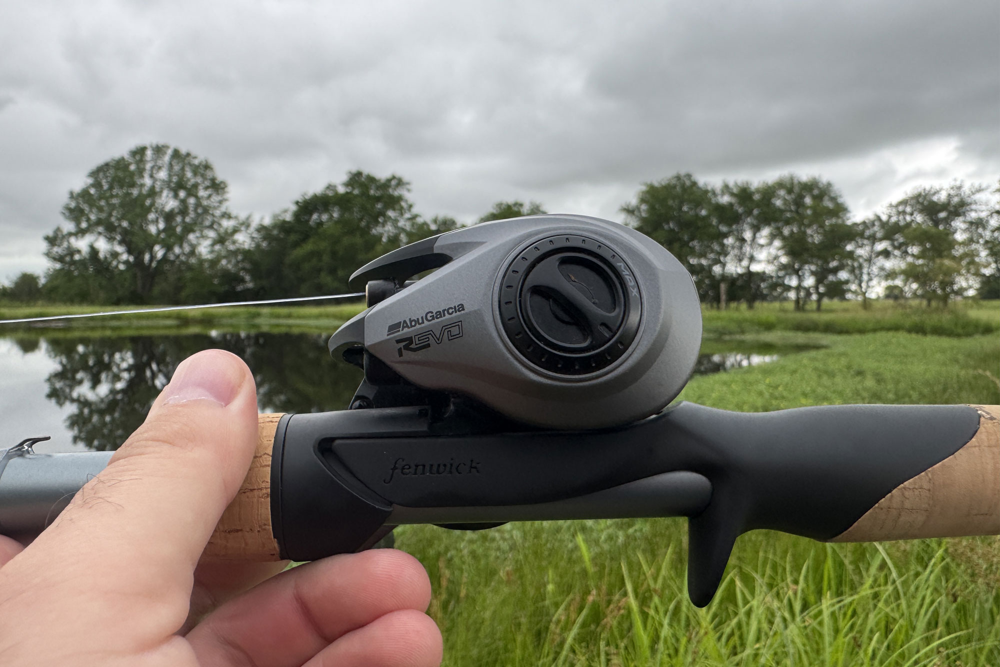a man holding Abu Garcia Revo SX Low Profile Reel