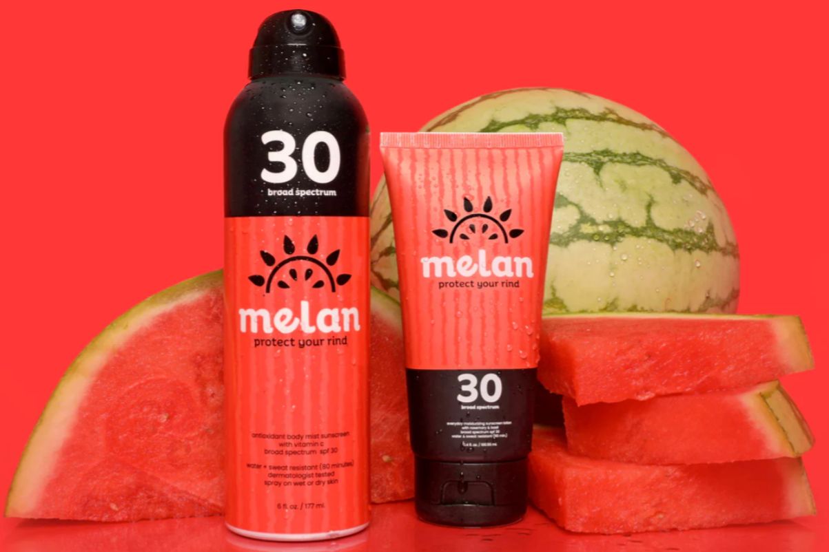 Melan Suncare bottles in front of watermelon