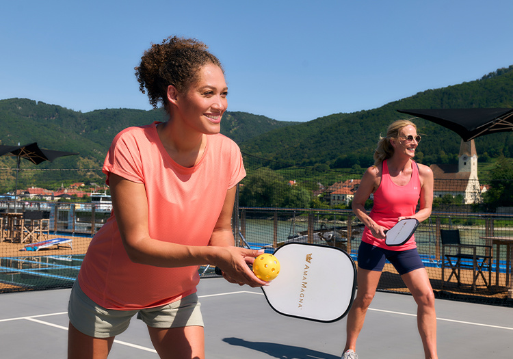 women playing pickleball on court