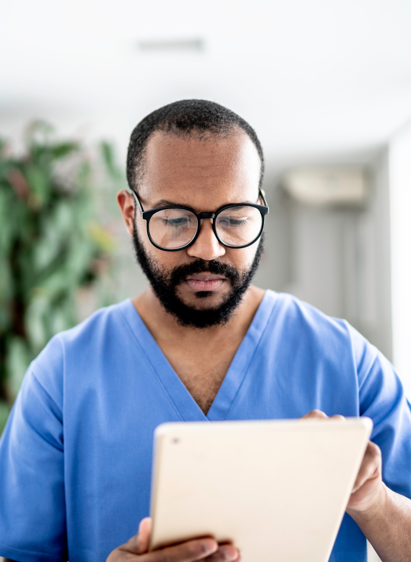 Male nurse using tablet at hospital