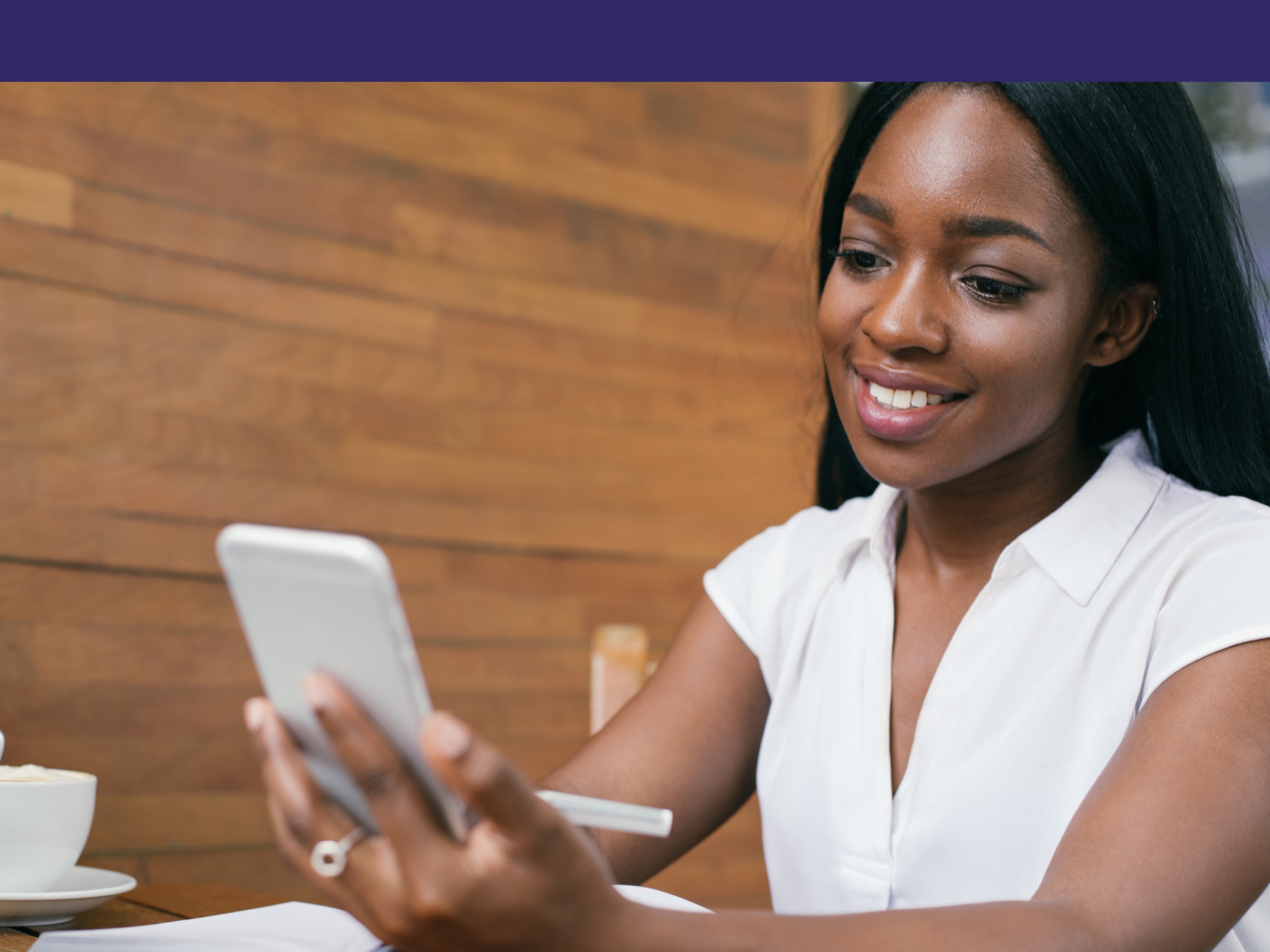 Beautiful stylish independent black woman working freelance in a chic cafe enjoying an afternoon of coffee and modern day empowerment 