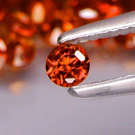 Outstanding 6.68ct diamond cut high fire Mozambique Garnet set