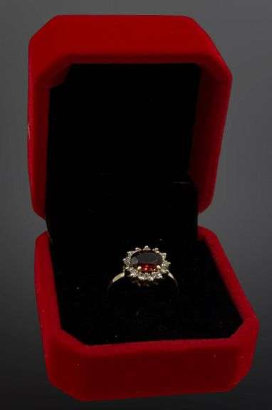 14kt Yellow gold oval garnet and diamond halo ring