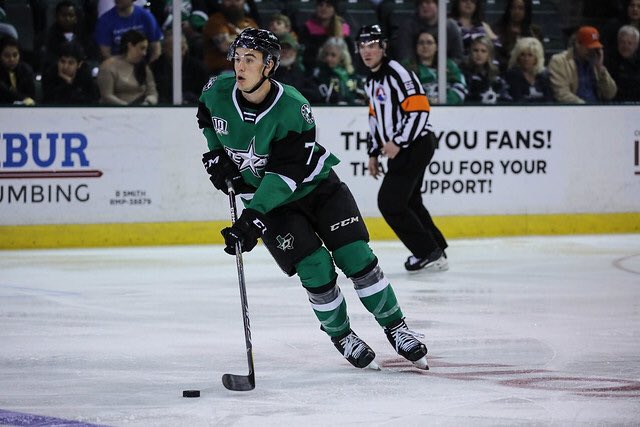 Texas Stars defenseman Gavin Bayreuther (#7) skates the puck up the ice in an American Hockey League game between the Texas S