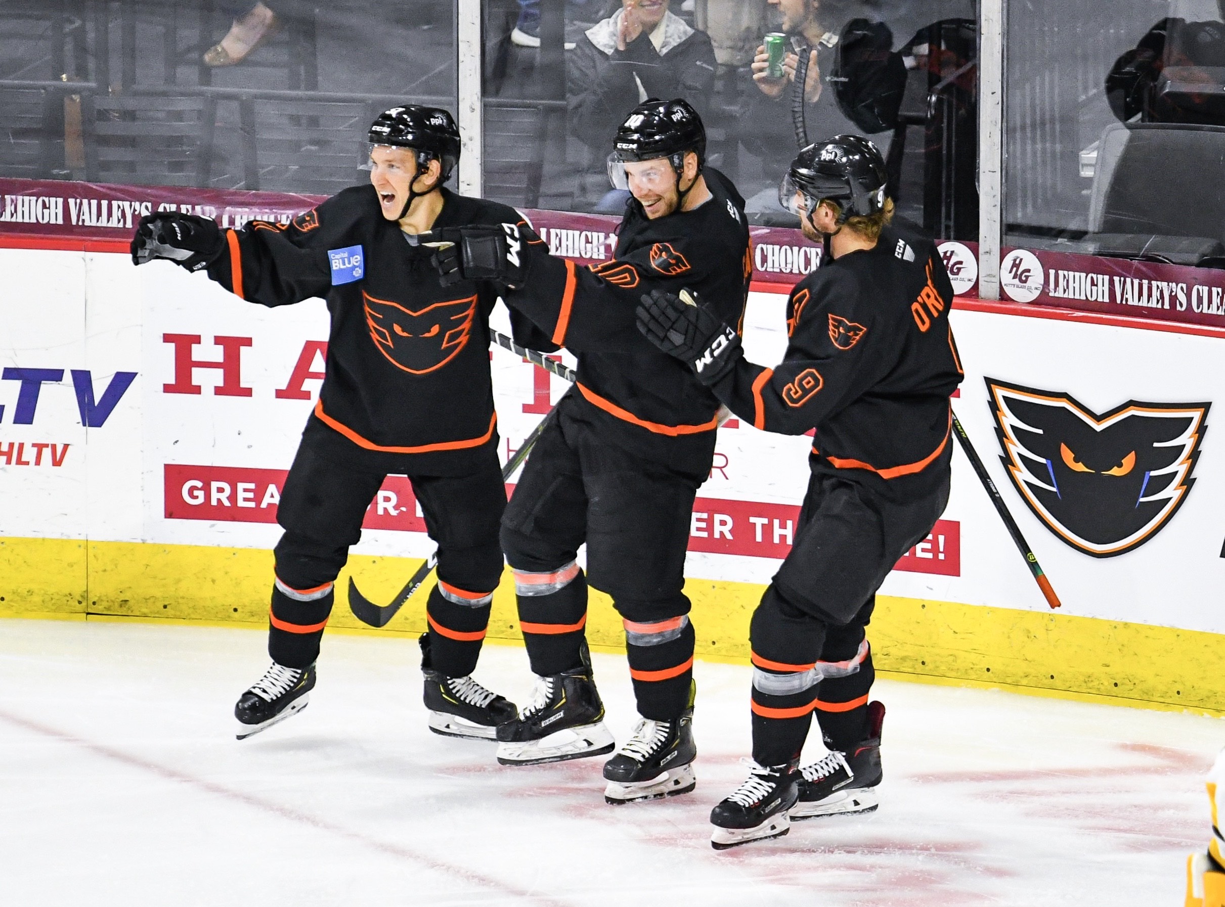 Greg Carey points back toward center ice for teammate T.J. Brennan after his clearing attempt bounced onto Carey's stick for