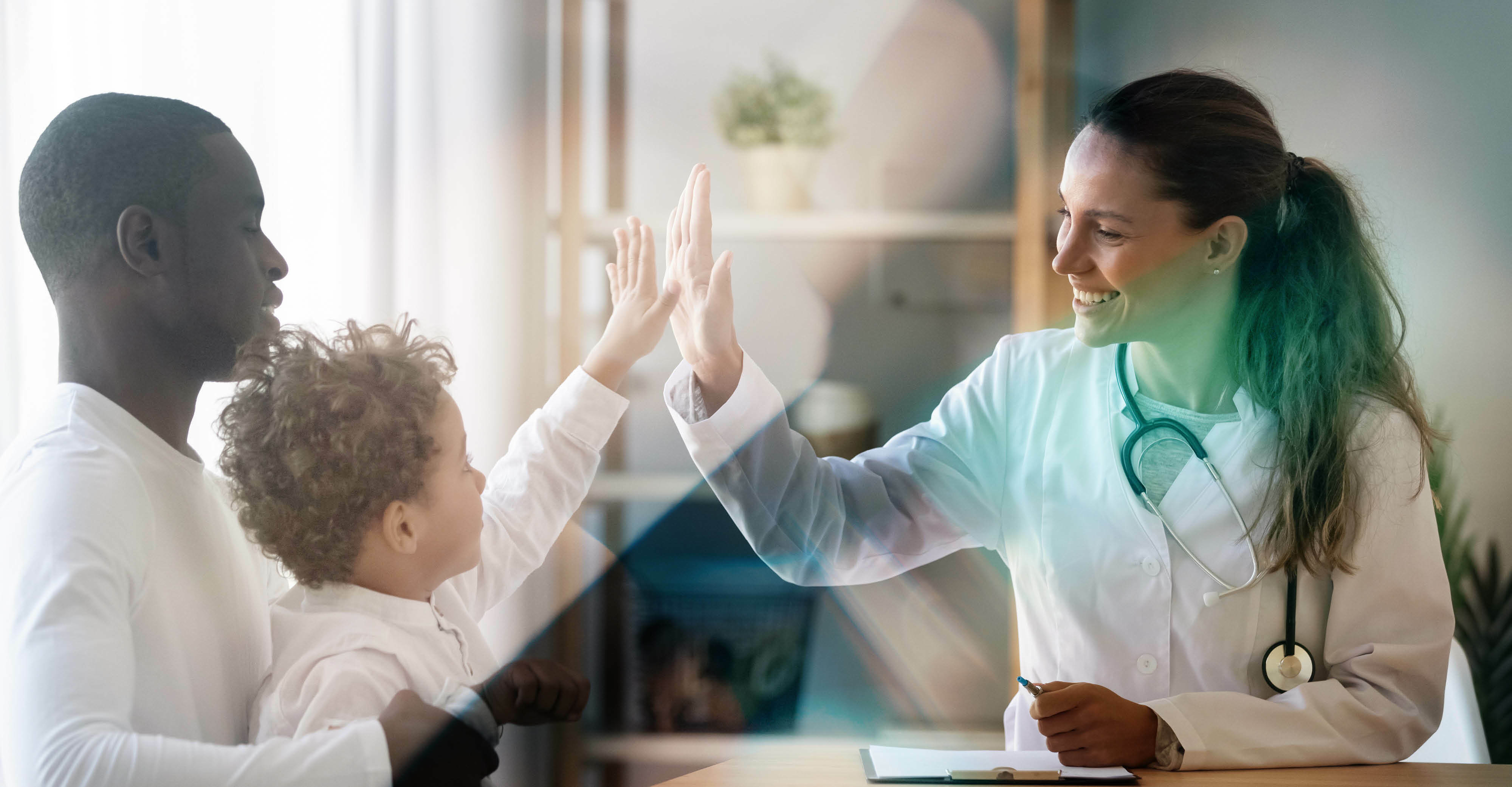 Happy  little child boy gives high five to female doctor pediatrician at medical  appointment