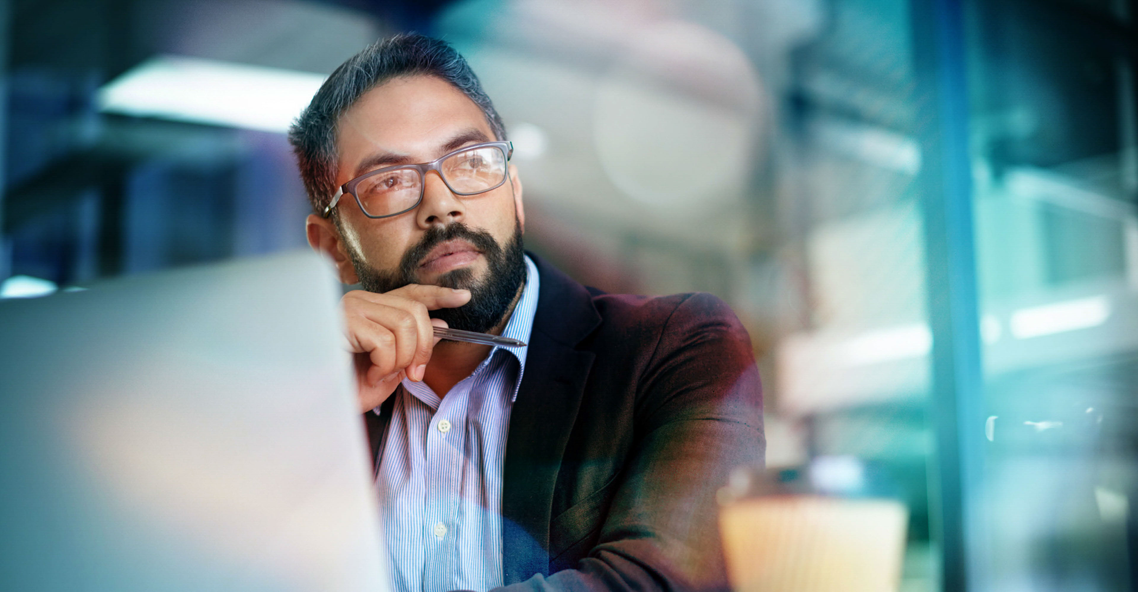 Shot of a mature businessman looking thoughtful while working on a laptop in an office