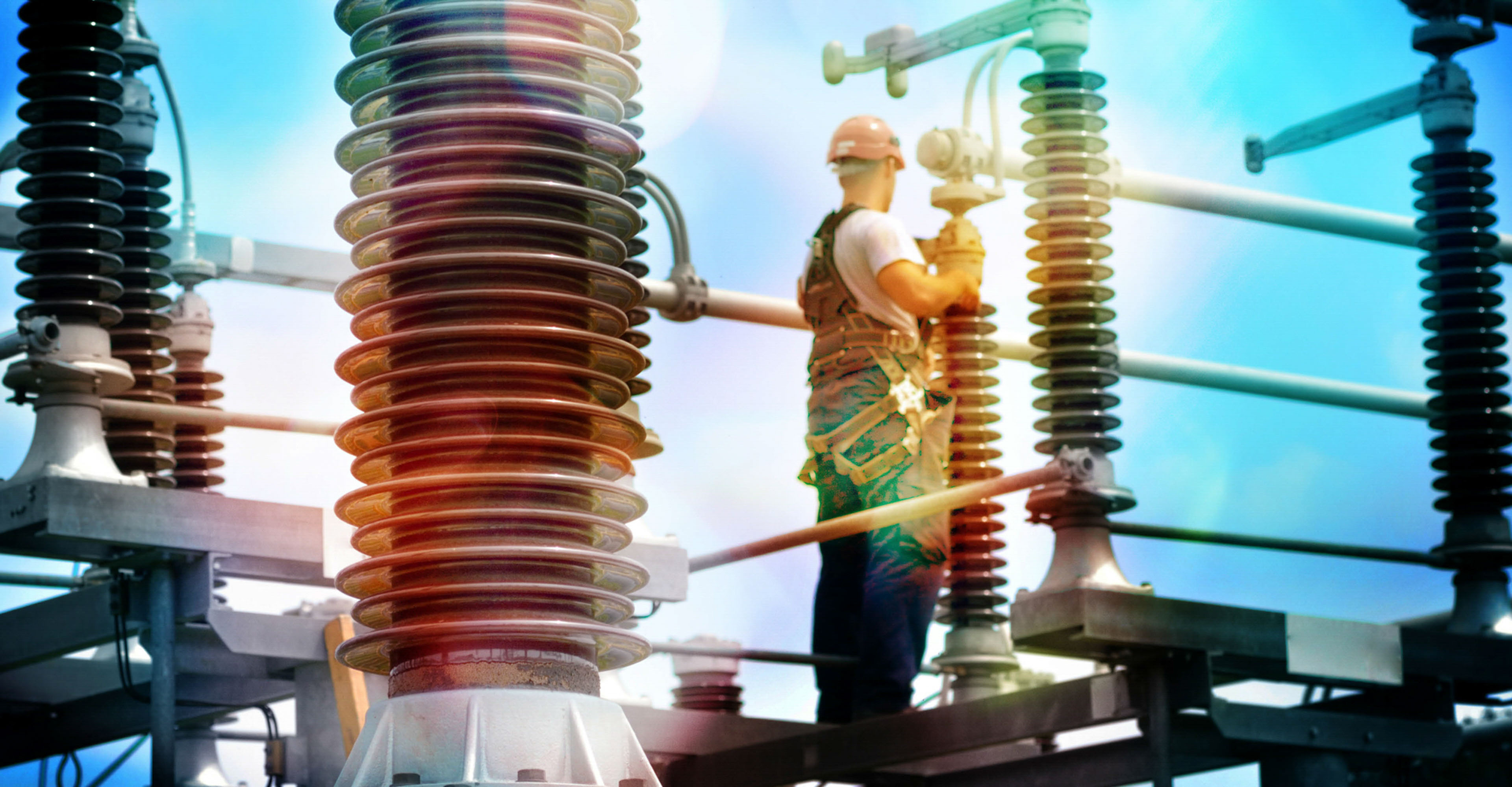 Construction worker with hadhat, protective workwear and safety belt working in power plant.